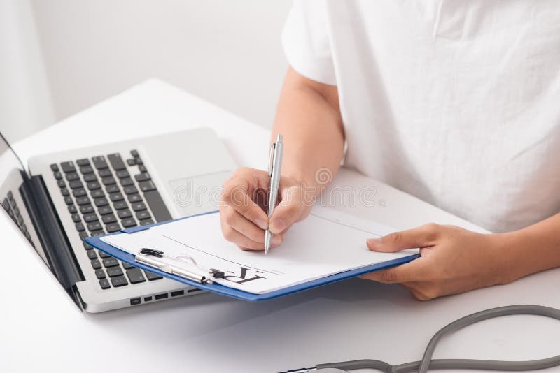 Füllende Patientenanamneseliste des Doktorhandgriffsilberstiftes am Klipp lizenzfreie stockbilder Füllende Patientenanamneseliste des Doktorhandgriffsilberstiftes am Klipp lizenzfreie stockbilder