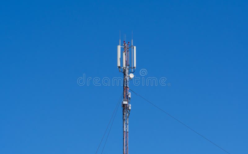 Technology on the top of the telecommunication GSM 4G tower antenna, transmitter, blue sky