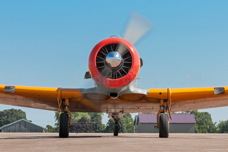 EDEN PRAIRIE, MN - JULY 16 2016: AT-6G Texan airplane straight on view of running propeller. The AT-6G Texan was primarily used as an advanced trainer aircraft after World War II and into the 1950s. EDEN PRAIRIE, MN - JULY 16 2016: AT-6G Texan airplane straight on view of running propeller. The AT-6G Texan was primarily used as an advanced trainer aircraft after World War II and into the 1950s