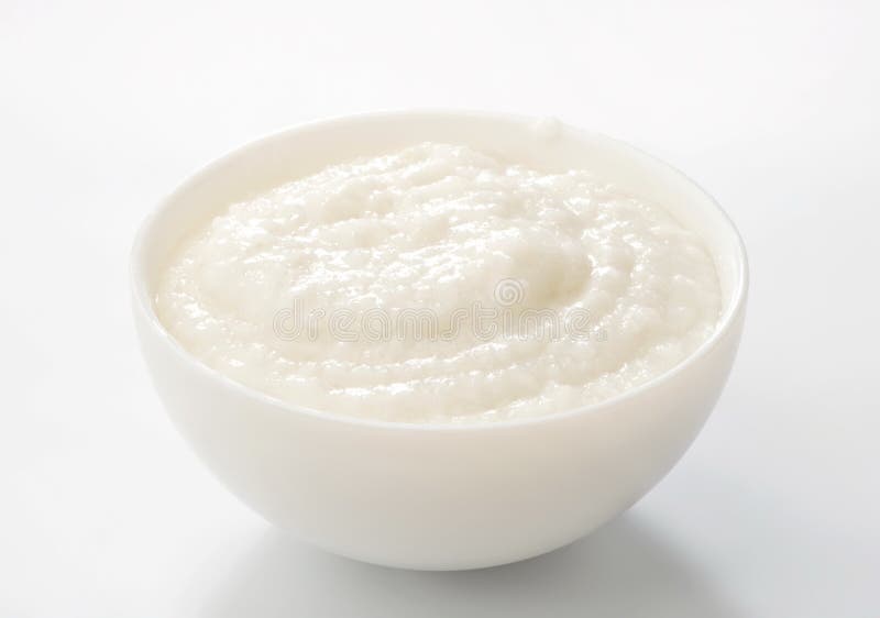 Rice porridge in porcelain bowl close-up on white. Rice porridge in porcelain bowl close-up on white