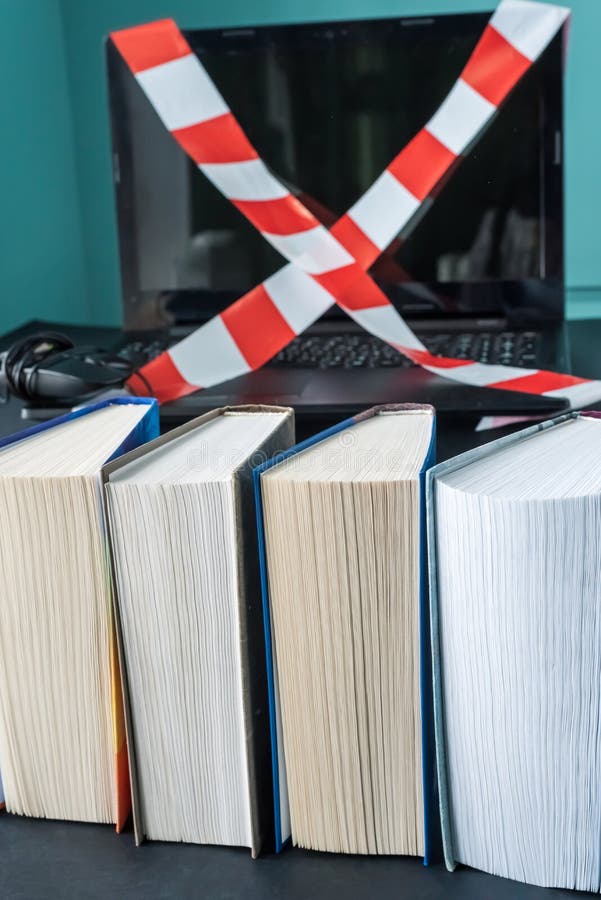 Gadget detox concept. Digital addiction concept. Books in the foreground. Gadget detox concept. Digital addiction concept. Books in the foreground.