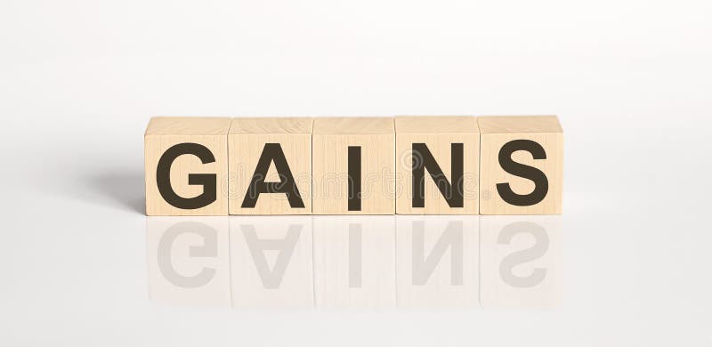 GAINS word from wooden blocks on the white desk