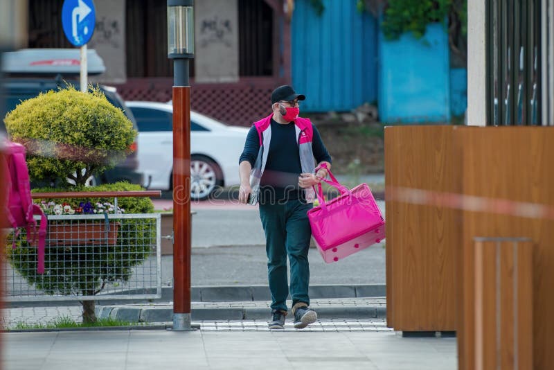 Galati, Romania - May 06, 2020: Food order online via Foodpanda being delivered by foodpanda delivery boy. Foodpanda is up coming online delivery company in Europe.