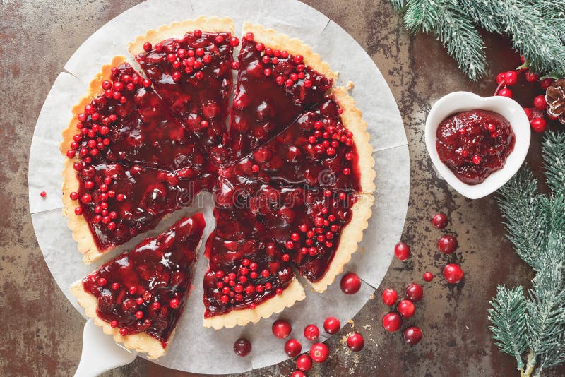 Delicious cranberry tart with jellied and fresh cranberries for Christmas. Top view, vintage toned. Delicious cranberry tart with jellied and fresh cranberries for Christmas. Top view, vintage toned