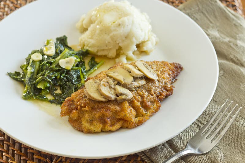 Crispy breaded chicken marsala with mashed potatoes and broccoli rabe with garlic. Crispy breaded chicken marsala with mashed potatoes and broccoli rabe with garlic