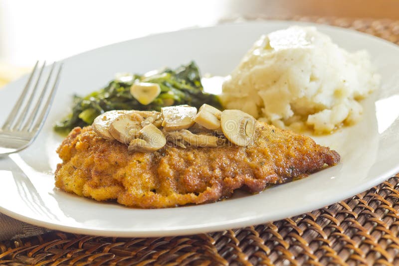 Crispy breaded chicken marsala with mashed potatoes and broccoli rabe with garlic. Crispy breaded chicken marsala with mashed potatoes and broccoli rabe with garlic