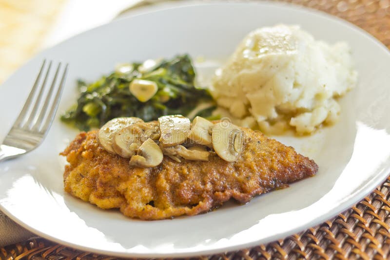 Crispy breaded chicken marsala with mashed potatoes and broccoli rabe with garlic. Crispy breaded chicken marsala with mashed potatoes and broccoli rabe with garlic