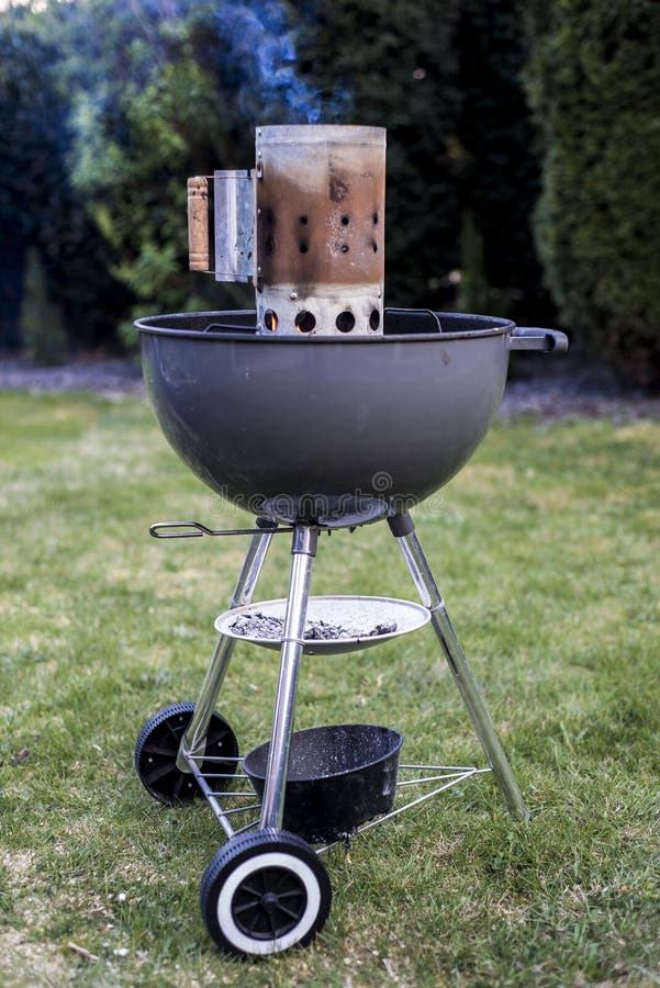 Kettle barbecue charcoal grill for roasting BBQ standing on gras ready for action. Kettle barbecue charcoal grill for roasting BBQ standing on gras ready for action