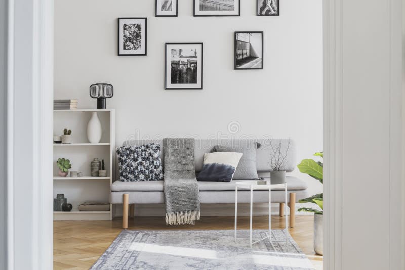 Gallery of black and white posters on the wall of classy living room interior royalty free stock photo