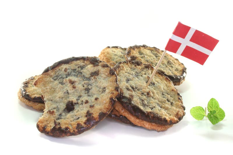 Oat cookies with chocolate filling and mint on a white background. Oat cookies with chocolate filling and mint on a white background