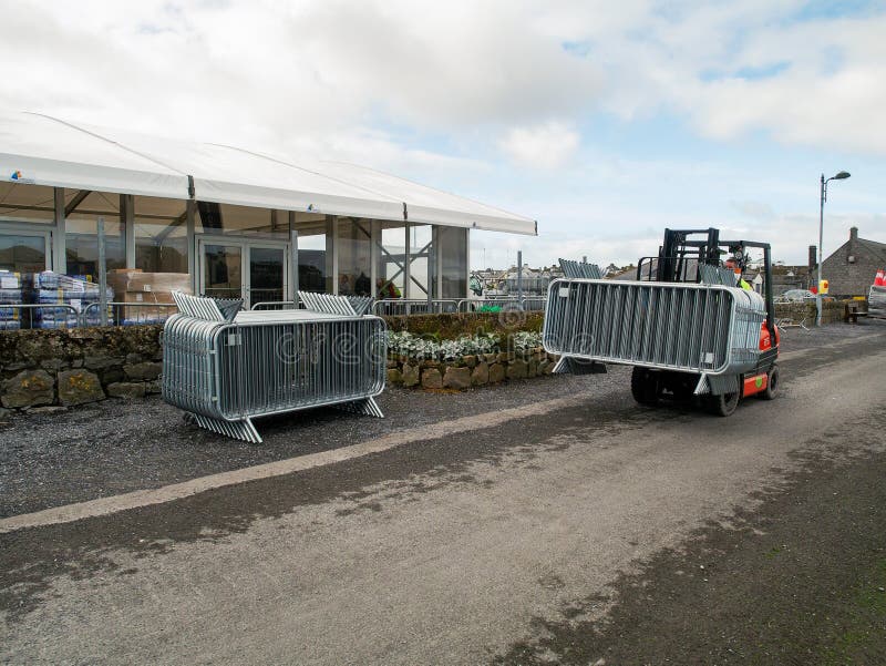 10/04/2019 Galway / Ireland: Stack of metal fences, another stack transported by forklift Temporary pavilion in the background. stock photography