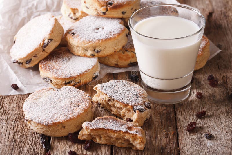 Tasty Welsh cakes with raisins and milk close-up on the table. horizontal. Tasty Welsh cakes with raisins and milk close-up on the table. horizontal