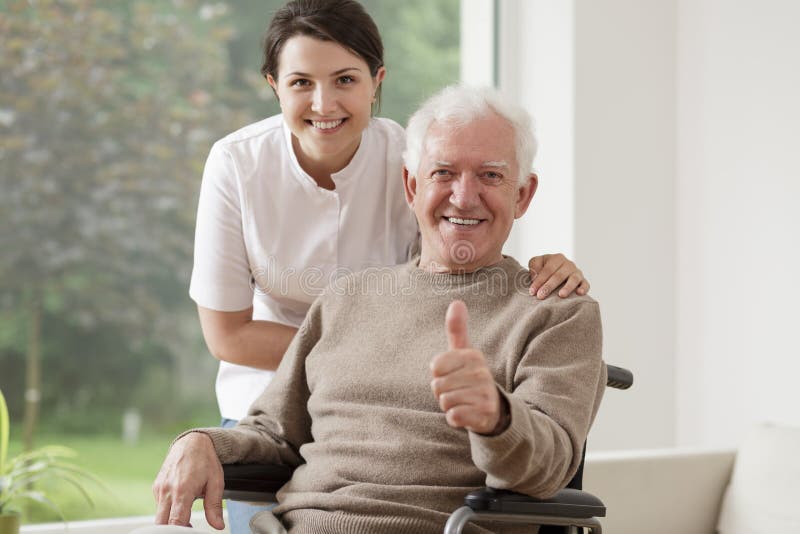 Old men on wheelchair holding thumb up. Old men on wheelchair holding thumb up