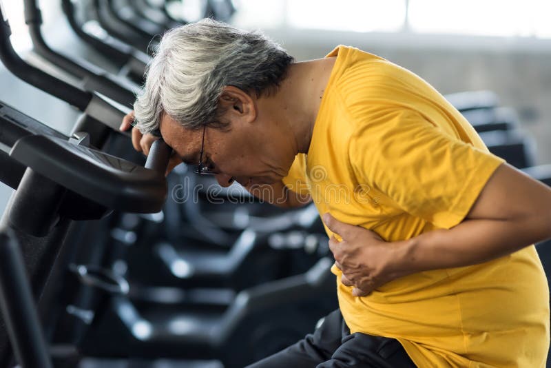 Senior man suffering from chest pain while exercising on biking machine in fitness gym. Old male guy heart attack. Elderly accident from sport training. Healthy lifestyle concept, ache, adult, age, aged, asian, body, cardiac, cardiology, cardiovascular, care, disease, emergency, exercise, failure, female, help, helpless, holding, hurt, infarction, injured, injury, mature, medical, myocardial, older, patient, people, person, retired, sick, stroke, wellness, workout. Senior man suffering from chest pain while exercising on biking machine in fitness gym. Old male guy heart attack. Elderly accident from sport training. Healthy lifestyle concept, ache, adult, age, aged, asian, body, cardiac, cardiology, cardiovascular, care, disease, emergency, exercise, failure, female, help, helpless, holding, hurt, infarction, injured, injury, mature, medical, myocardial, older, patient, people, person, retired, sick, stroke, wellness, workout