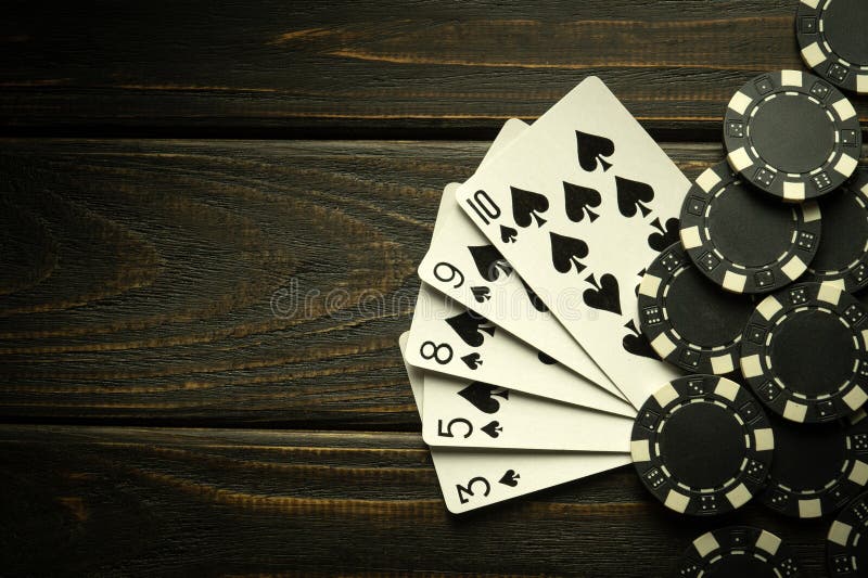 Gambling playing poker with a winning straight flush combination. Cards with chips on a black vintage table in a poker club