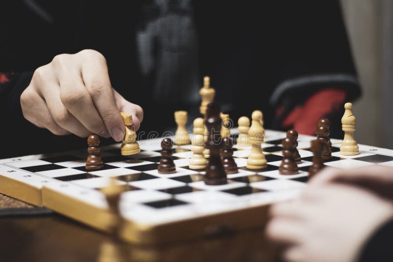 Hand Of A Man Taking A Chess Piece To Make The Next Move In A Chess Game.  Close Up. Spring Day Outside. Stock Photo, Picture and Royalty Free Image.  Image 198493516.