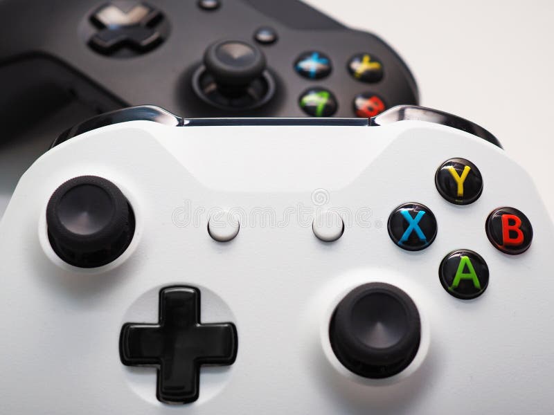 Game console controller isolated on white. Two game console controllers isolated on white background. One white and one black