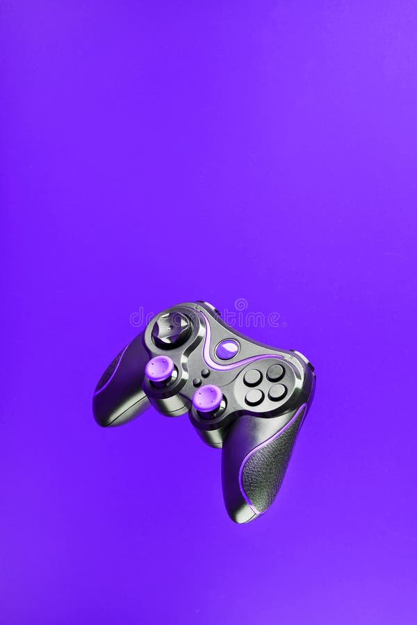 Game controller gamepad with pink buttons on lilac background