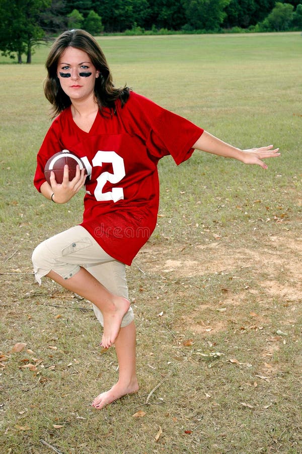 Young woman with football doing classic pose. Young woman with football doing classic pose.