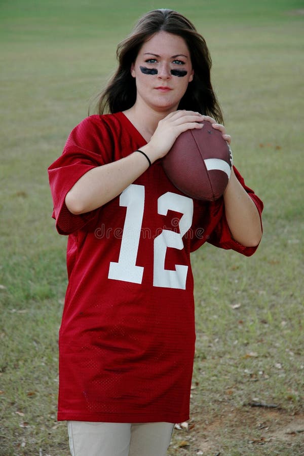 Young woman with football ready to throw pass. Young woman with football ready to throw pass.