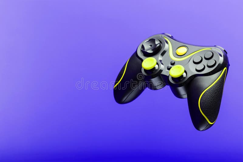 Gamepad game controller with yellow buttons on the purple background