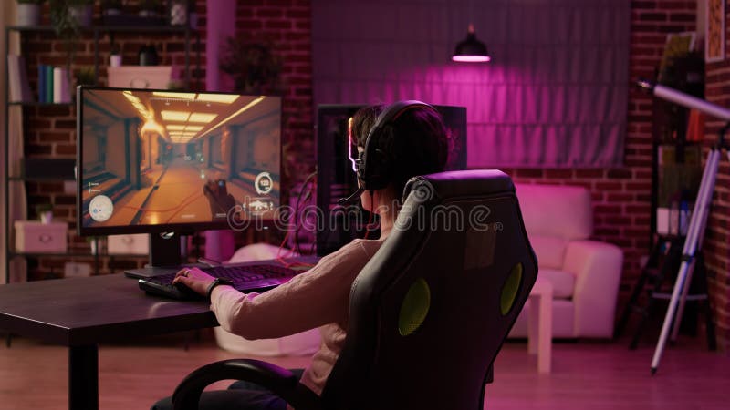 Esport of pro gamer playing video game with new graphics winning  championship, stylish design cyber games room. Virtual shooter game in  cyberspace, esports player performing on pc gaming tournament Stock Photo