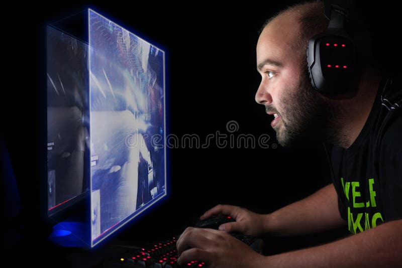 Person playing video games with controller on computer Stock Photo