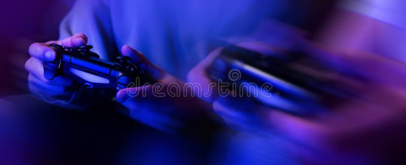 gamers playing console video games. controller in hands closeup. neon lights