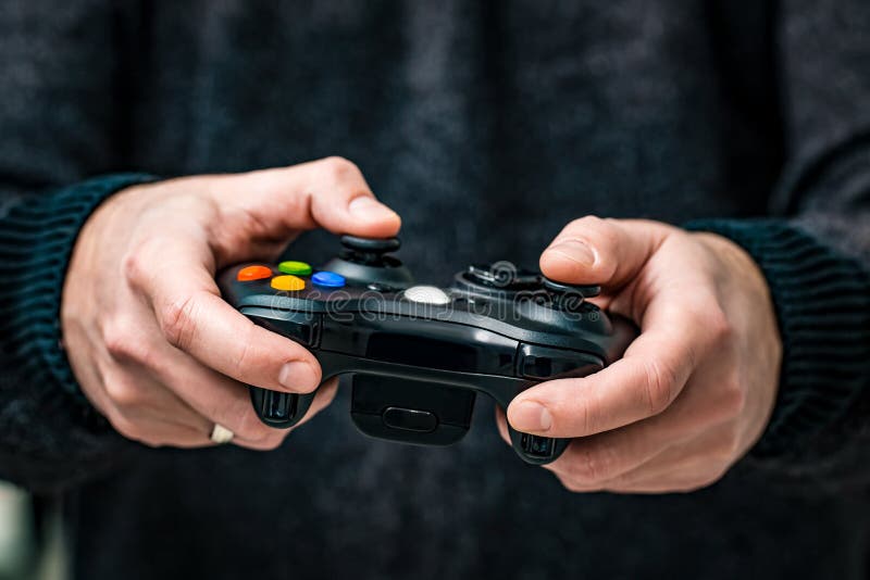 Free Photo  Person playing video games with controller on computer. player  using joystick and wearing headphones to play online game on monitor.  modern man using gaming equipment to have fun.