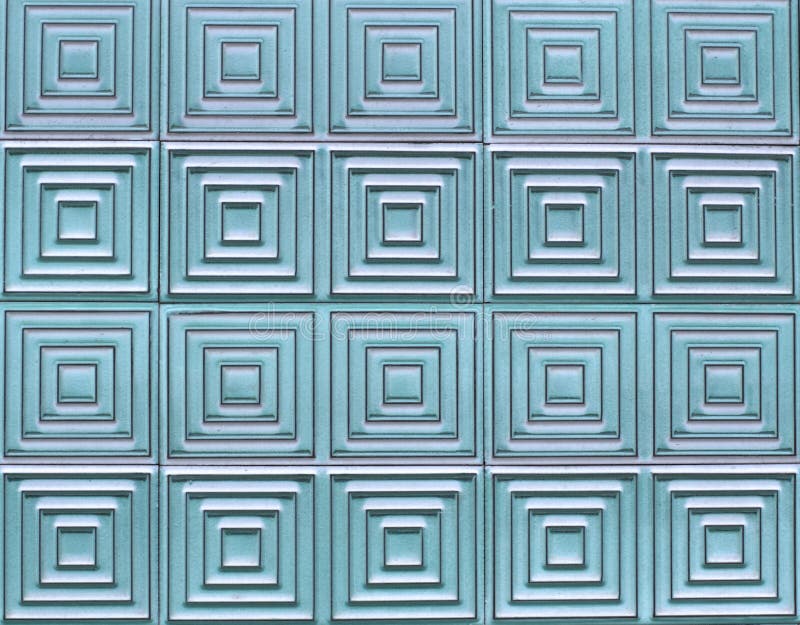 Old tiles on the wall with a unique square pattern, turquoise color. Old tiles on the wall with a unique square pattern, turquoise color.