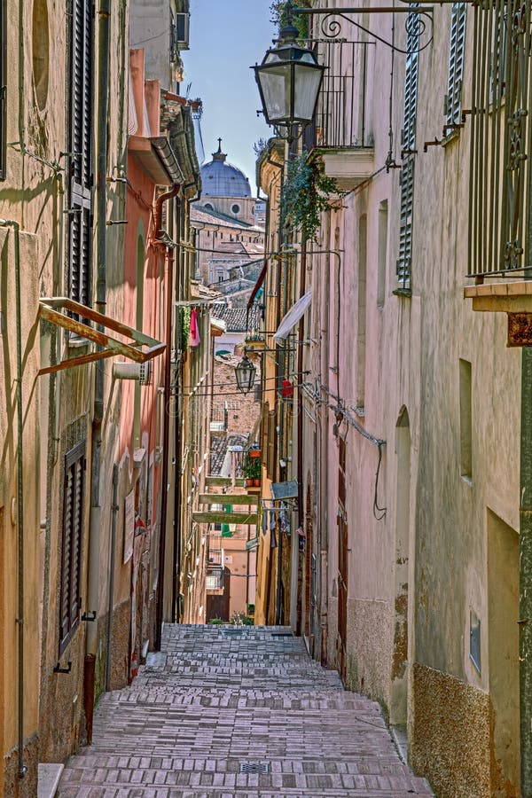 Picturesque old narrow alley with stairway and cathedral on background in the ancient town Lanciano, Abruzzo, Italy. Picturesque old narrow alley with stairway and cathedral on background in the ancient town Lanciano, Abruzzo, Italy