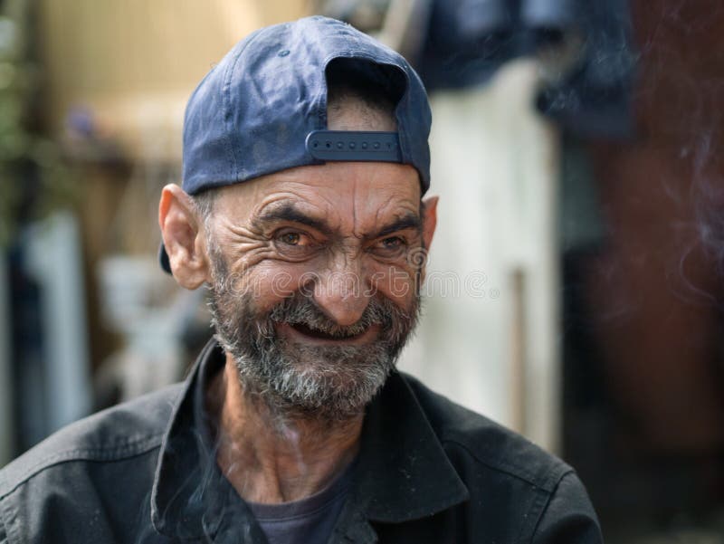 Old and ugly homeless man laughing. Old and ugly homeless man laughing