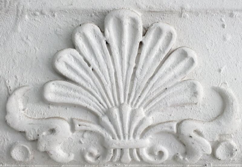 Old stucco molding. Vintage decorative element on white wall texture. Old stucco molding. Vintage decorative element on white wall texture.