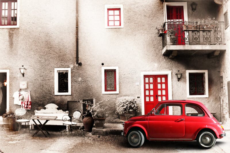 An old Italian house with a small subcompact old red car. Vintage scene. Two chairs, a bench and a small table outside the home. A balcony with flowers and other objects of another era. Doors and windows red. An old Italian house with a small subcompact old red car. Vintage scene. Two chairs, a bench and a small table outside the home. A balcony with flowers and other objects of another era. Doors and windows red.