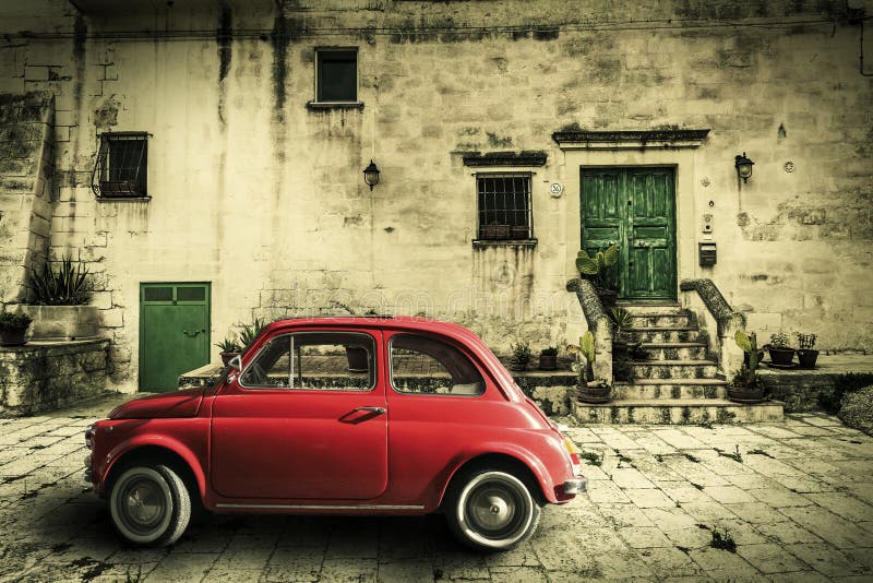 An old Italian with out a small subcompact old car. Vintage scene. Historical Italian home. Vignetting. Location: Matera, Italy. An old Italian with out a small subcompact old car. Vintage scene. Historical Italian home. Vignetting. Location: Matera, Italy