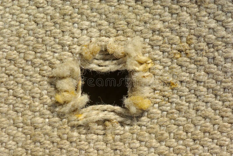 Old textured canvas background. worn tattered fabric with holes. Old textured canvas background. worn tattered fabric with holes