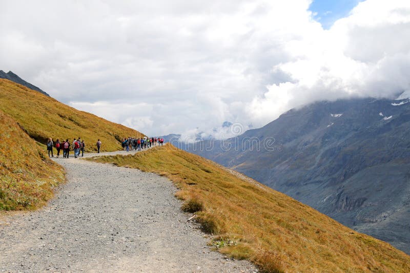 Hikers walking on a Gamsgrube Nature hiking trail along the Pasterze Glacier at Grossglockner, Austria on September 16, 2014. Pasterze Glacier is the longest mountain glacier in Austria at approximately 8.4 km in length. Hikers walking on a Gamsgrube Nature hiking trail along the Pasterze Glacier at Grossglockner, Austria on September 16, 2014. Pasterze Glacier is the longest mountain glacier in Austria at approximately 8.4 km in length.