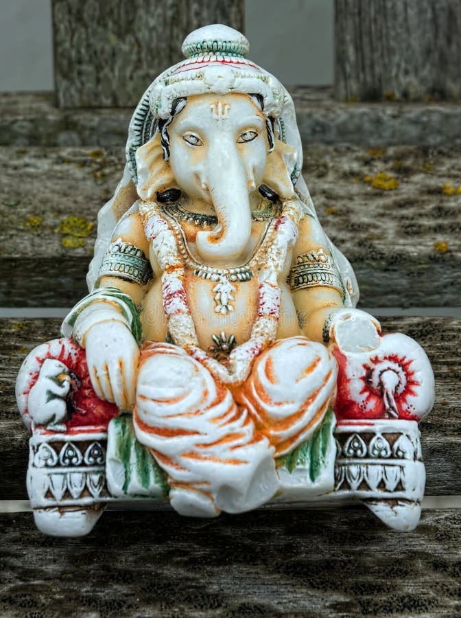 Ganesha. Hindu Deity, hand carved & painted statuette. Ganesha is the elephant-headed Hindu god, widely revered as the remover of obstacles, the patron of arts royalty free stock image