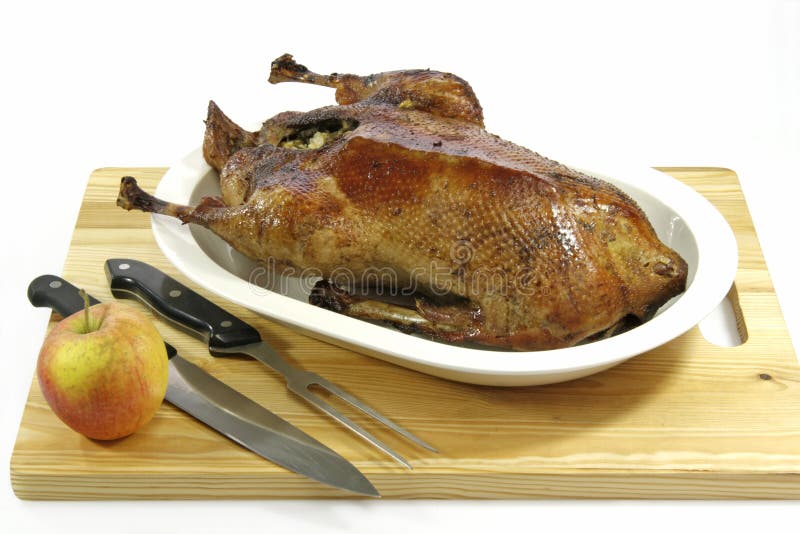 Crunchy roasted goose stuffed with apples on a plate. Crunchy roasted goose stuffed with apples on a plate