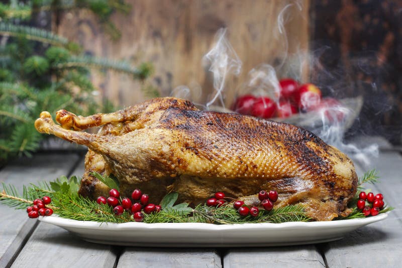 Baked goose on wooden table. Popular christmas dish. Baked goose on wooden table. Popular christmas dish