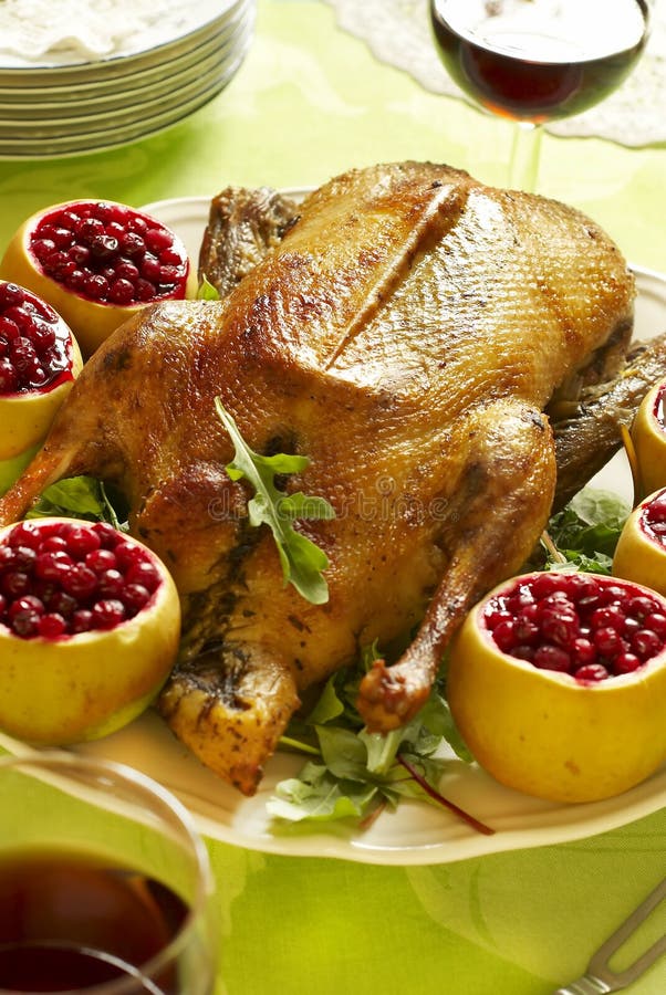 Christmas roast goose with apples stuffed with cranberries. Christmas roast goose with apples stuffed with cranberries