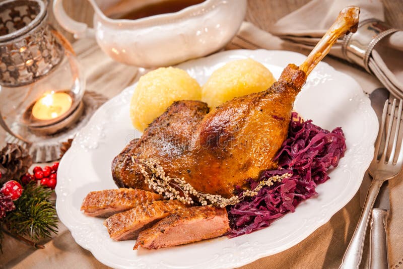 Crusty Christmas goose leg with braised red cabbage and dumplings. Crusty Christmas goose leg with braised red cabbage and dumplings
