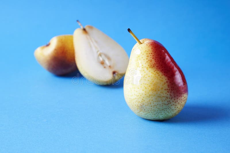Ganze frische reife Birnen trägt auf blauem Hintergrund, modernes Artlebensmittelbild, Sommertapetendesign Früchte lizenzfreie stockfotografie Ganze frische reife Birnen trägt auf blauem Hintergrund, modernes Artlebensmittelbild, Sommertapetendesign Früchte lizenzfreie stockfotografie