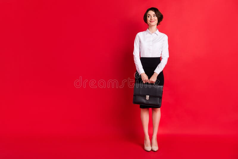 Full length body profile photo business woman keeping leather diplomat looking blank space isolated vivid red color background. Full length body profile photo business woman keeping leather diplomat looking blank space isolated vivid red color background.