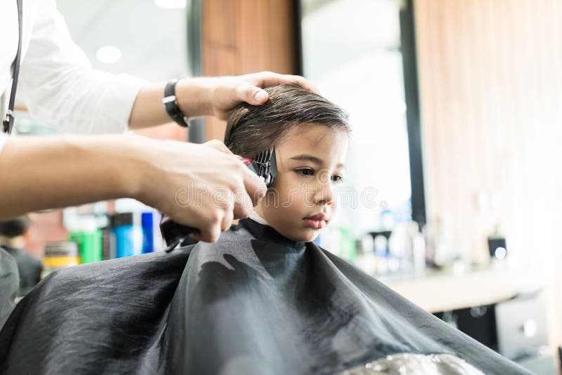 Garçon Ayant La Coupe De Cheveux Avec Le Peigne Et Les Ciseaux Chez Barber  Shop Image stock - Image du enfant, propriétaire: 123149349