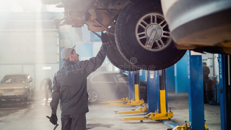 Garage automobile service - a mechanic checks the transmission