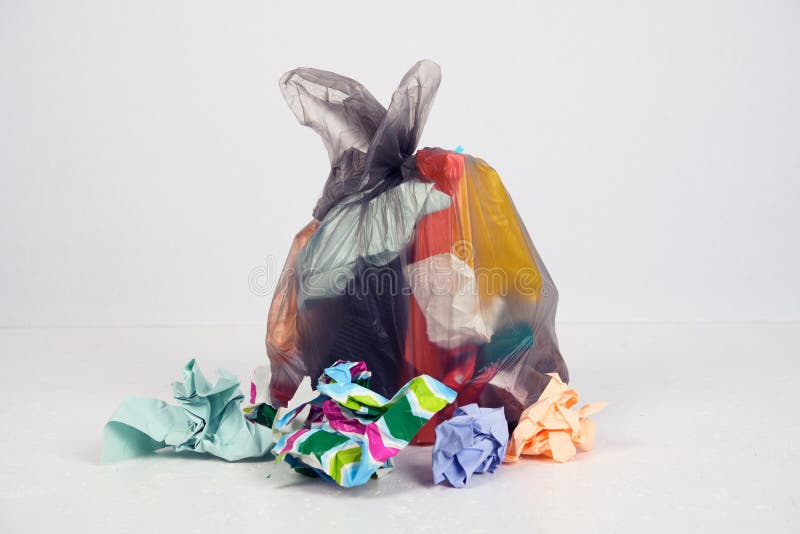 Garbage bag with defferent content in front of light background