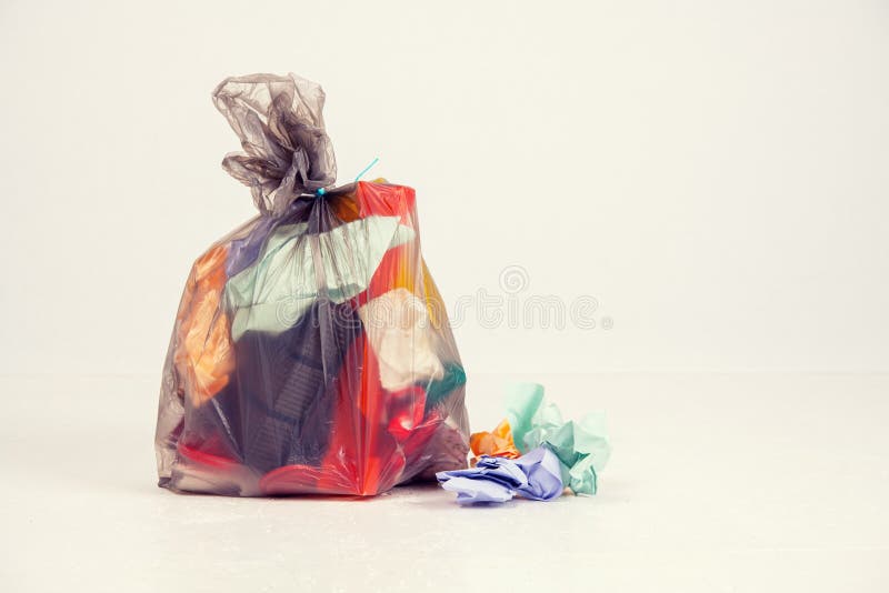 Garbage bag with defferent content in front of light background