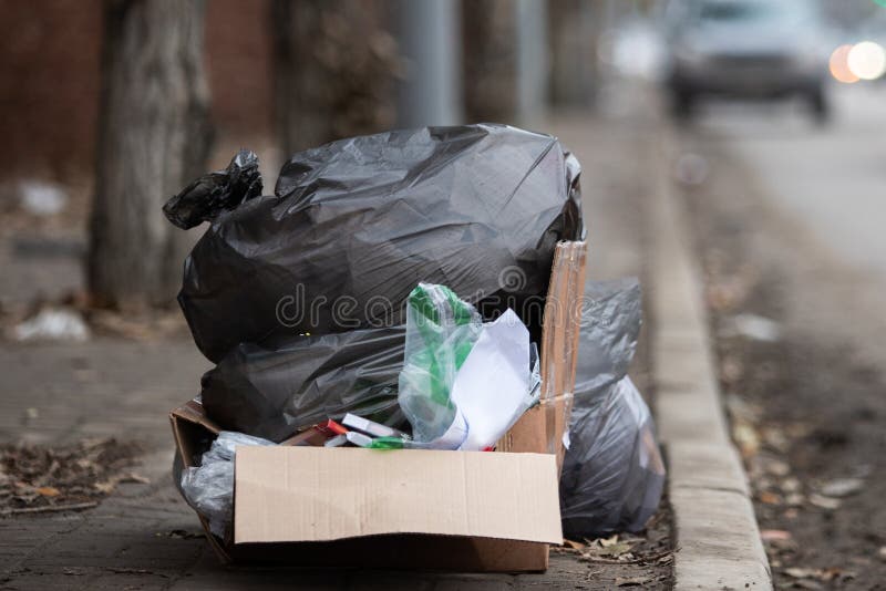 Premium Photo  A large black garbage bag on the side of the road