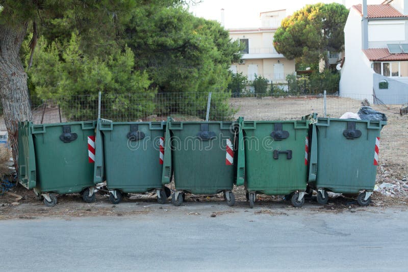 Garbage bins. Old green trash bins outdoors royalty free stock photo